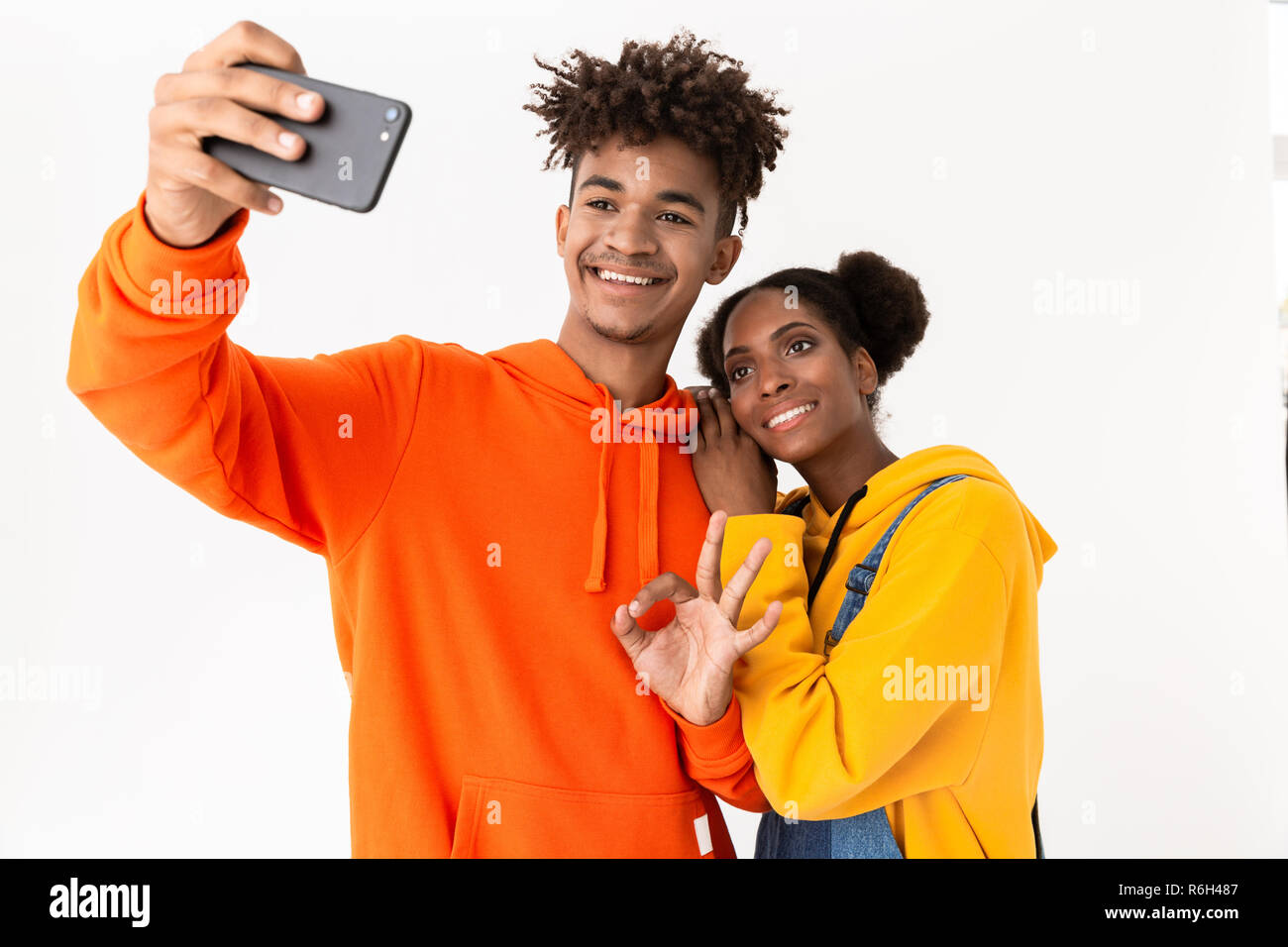 Portrait of a two joyful young african couple isolated over white ...