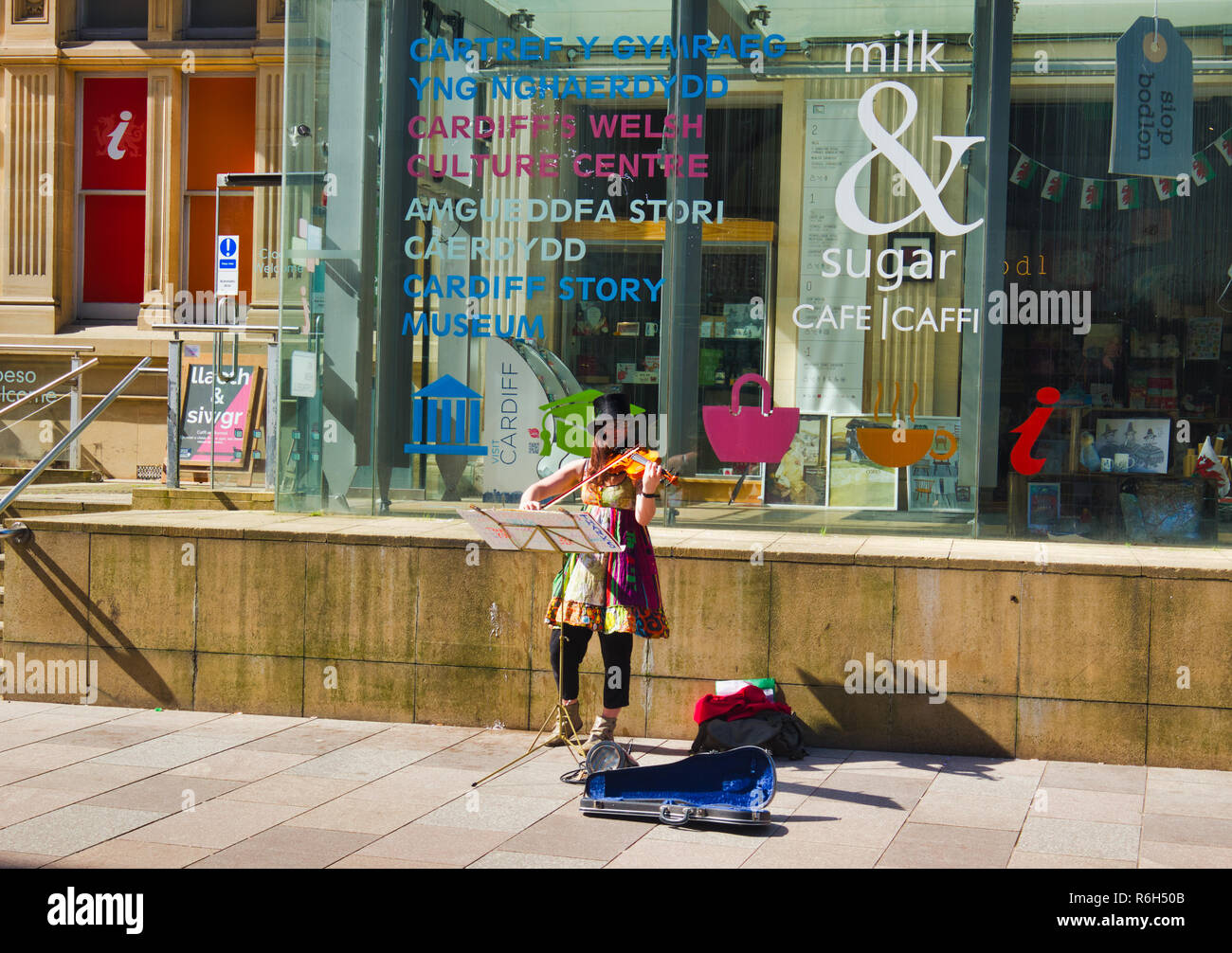 Female violin busker outside the Cardiff Story Museum, The Hayes, Cardiff, Wales, United Kingdom Stock Photo