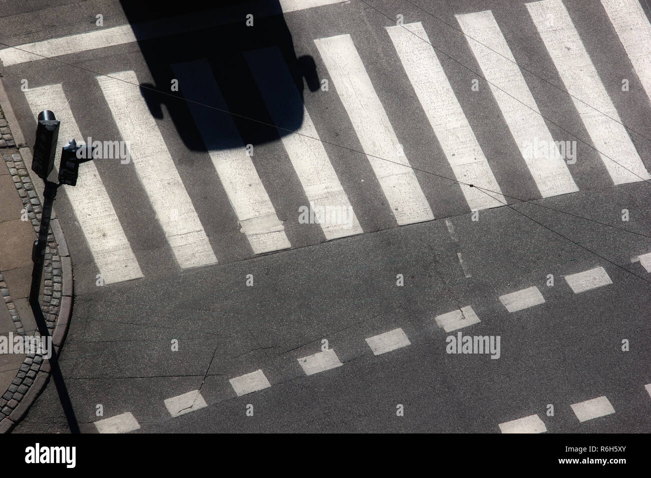 High angle shot of outline and shadow of car and wing mirrors stopped at zebra crossing, Copenhagen, Denmark, scandinavia Stock Photo