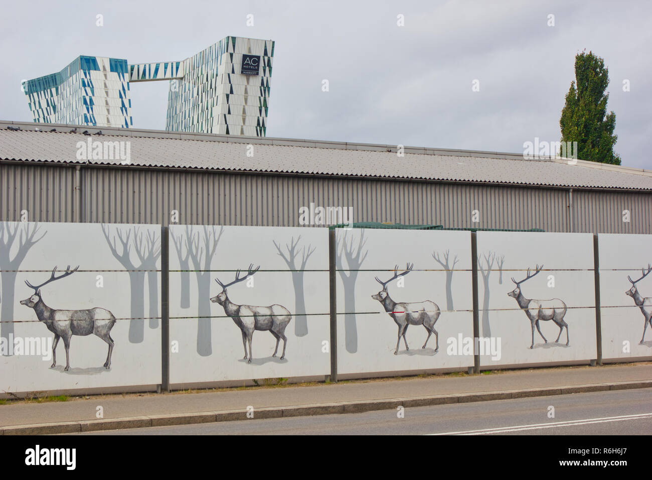 Hoarding of deer in forest with AC Bella Hotel Sky in the background, Orestad, Copenhagen, Denmark, Scandinavia Stock Photo