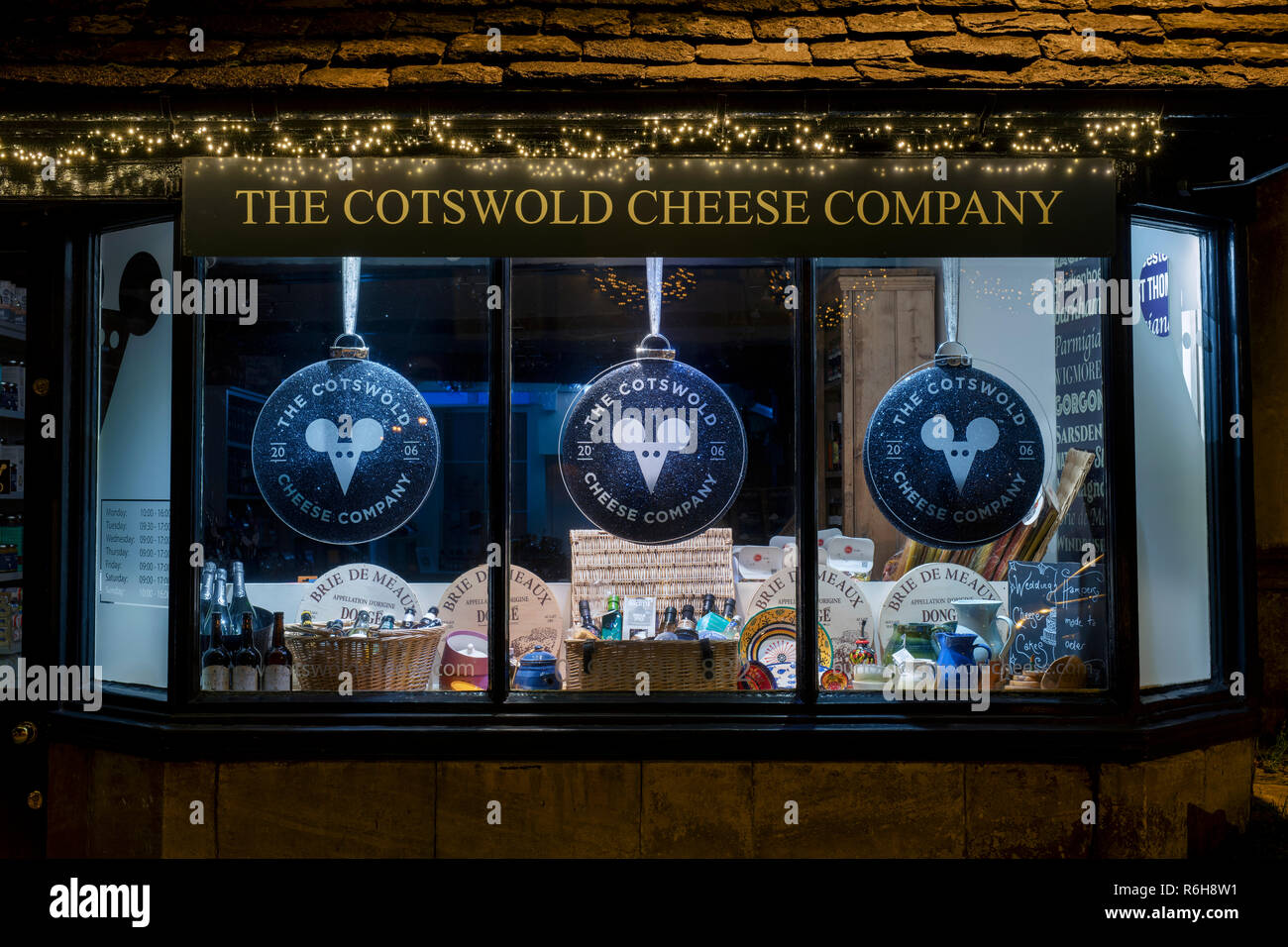 The Cotswold cheese company shop window at night in December. Burford