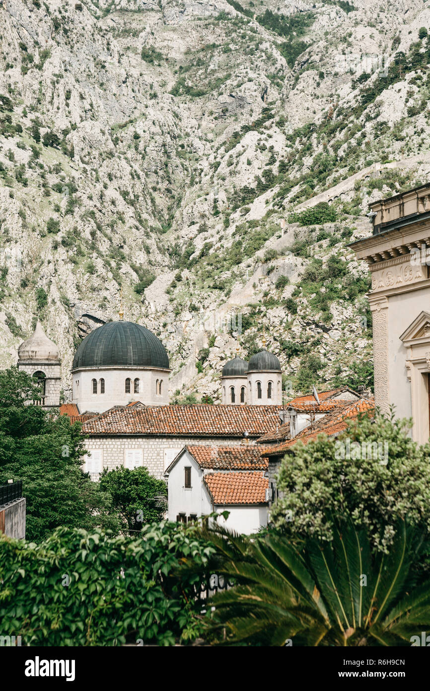 Beautiful view of the domes of the Orthodox Church in Kotor in Montenegro. Religious building. In the background is a mountain. Stock Photo