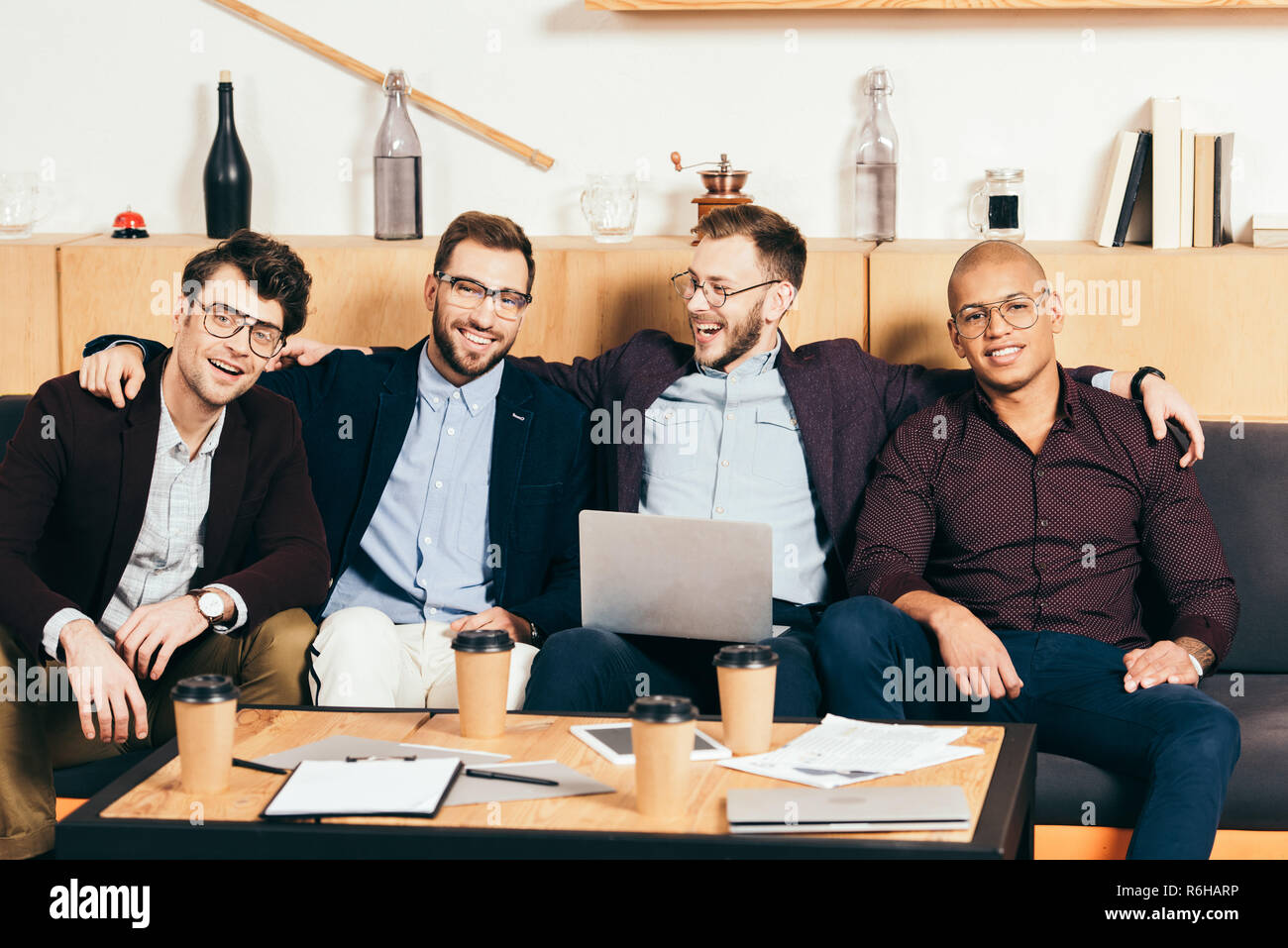 portrait of smiling young multiracial business colleagues in cafe Stock ...