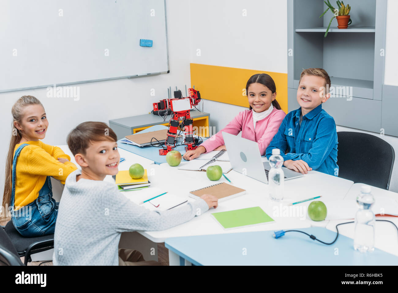 joyful children looking at camera at STEM robotics lesson Stock Photo ...
