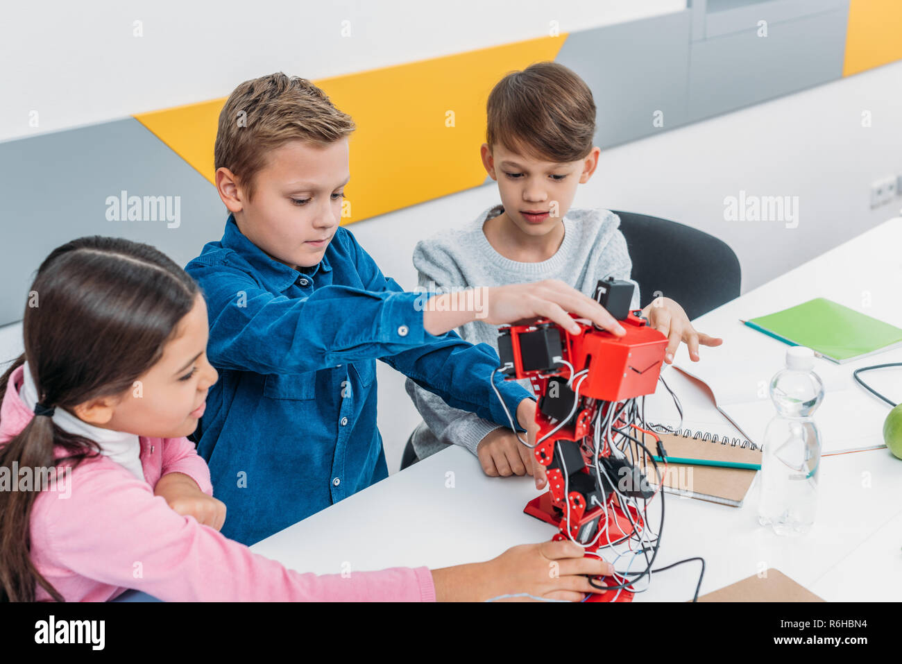 schoolchildren touching red electric robot in stem class Stock Photo ...