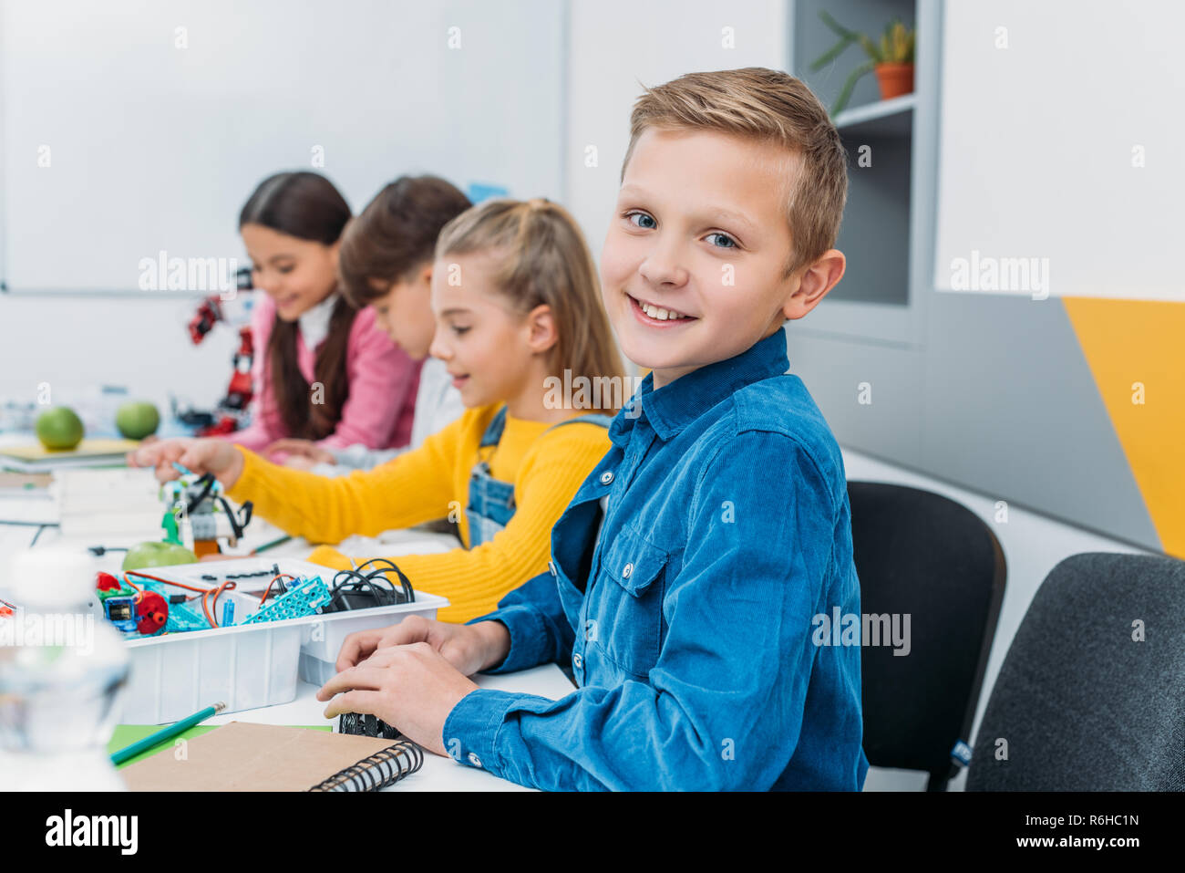 schoolboy rejoicing making a robot during STEM robotics lesson Stock ...