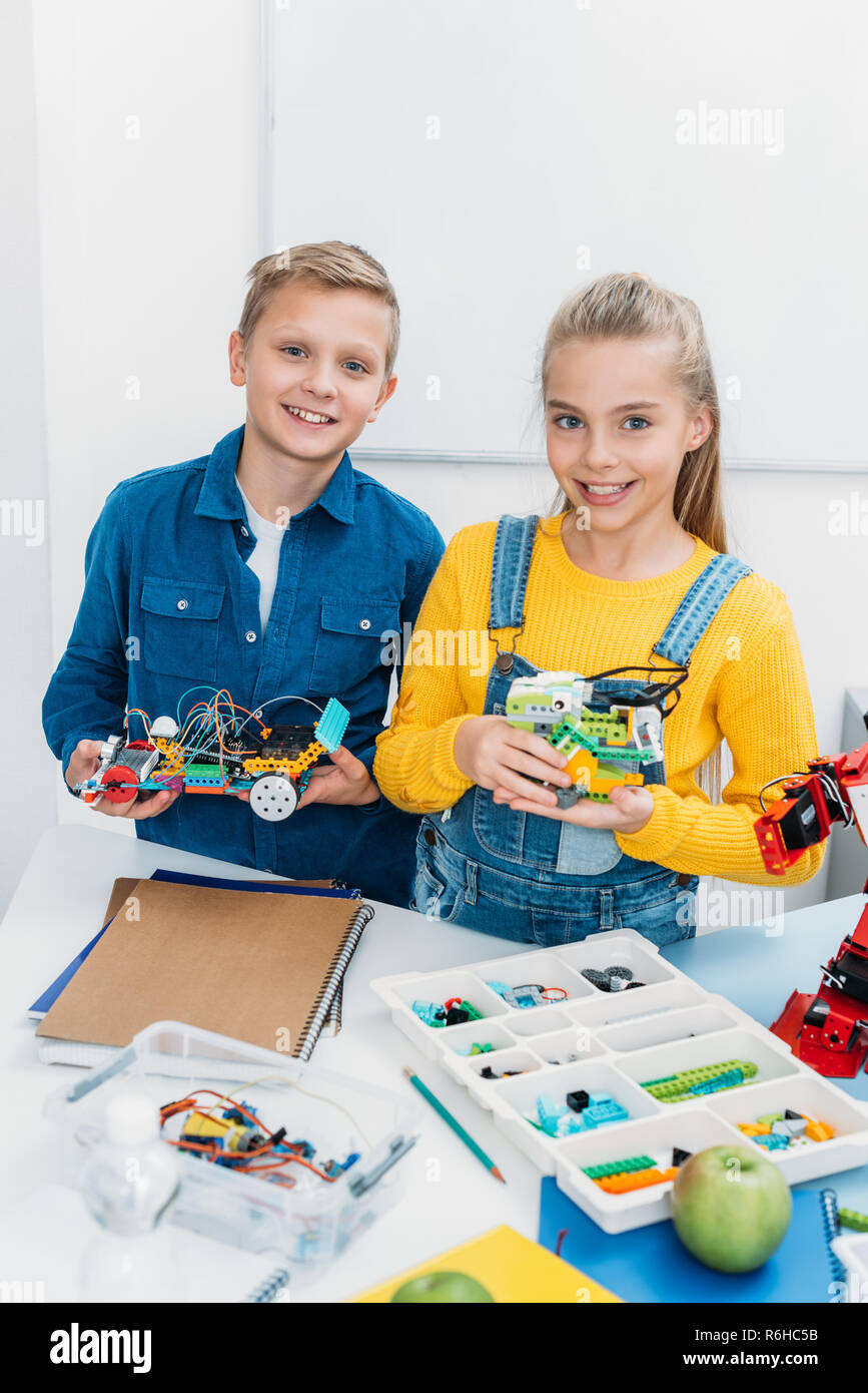 smiling children holding electric robots in stem education class Stock ...