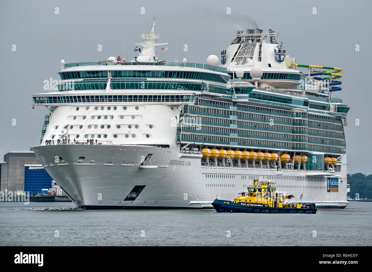 Rotterdam, The Netherlands, August 29, 2018: Cruise ship Indepence of the Seas is greeted by a small vessel of the Port Authority Stock Photo