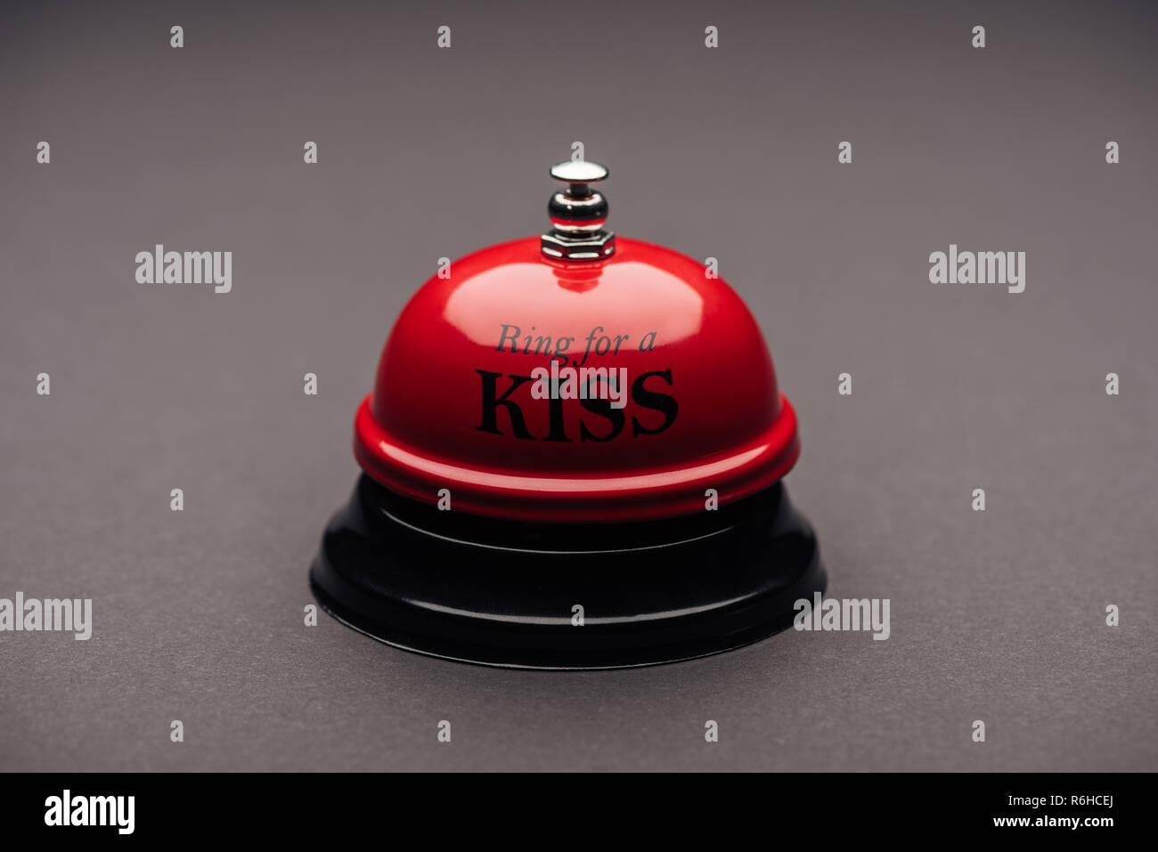close up of red service bell with ring for a kiss lettering isolated on  grey Stock Photo - Alamy