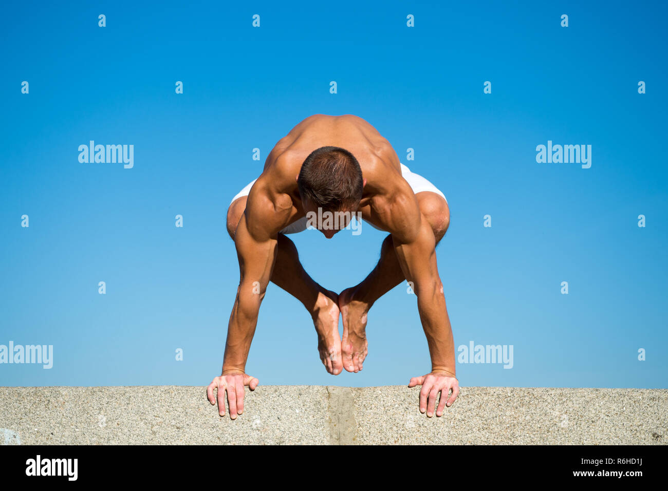 Muscular Man Balance Yoga Position Yoga Instructor With Muscular Body Stretching Sport And Health Care Coach Demonstrate Yoga Asana Outdoors Flexible Body Is His Merit Mental And Physical Health Stock Photo