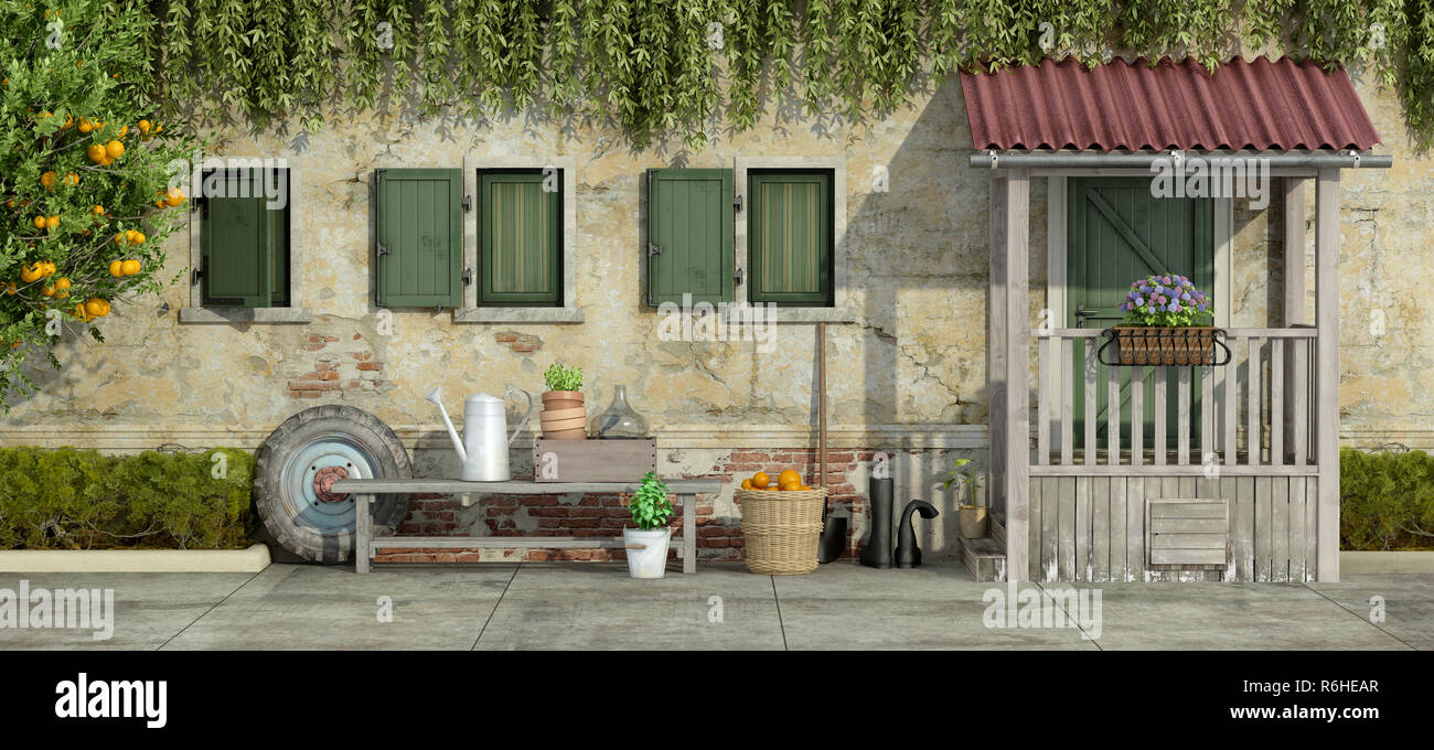 Old facade with gardening tools Stock Photo