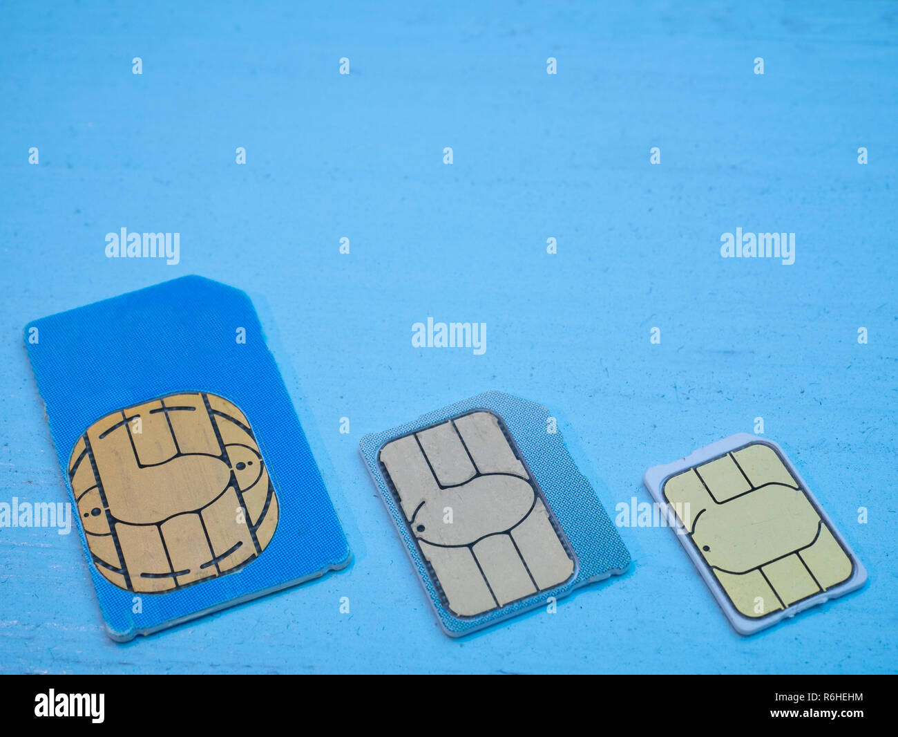 three sim cards standart, micro, nano 4g lte 5g ready on blue background. low angle shot Stock Photo
