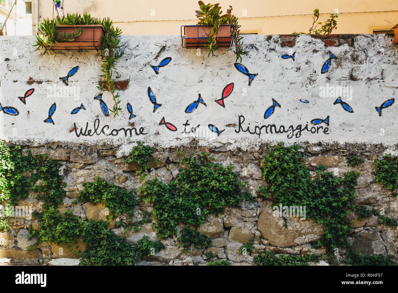 Riomaggiore, Italy - October 30, 2016: Welcome to Riomaggiore sign in Riomaggiore, one of Cinque Terre villages, on a bright day. Cinque Terre was inc Stock Photo
