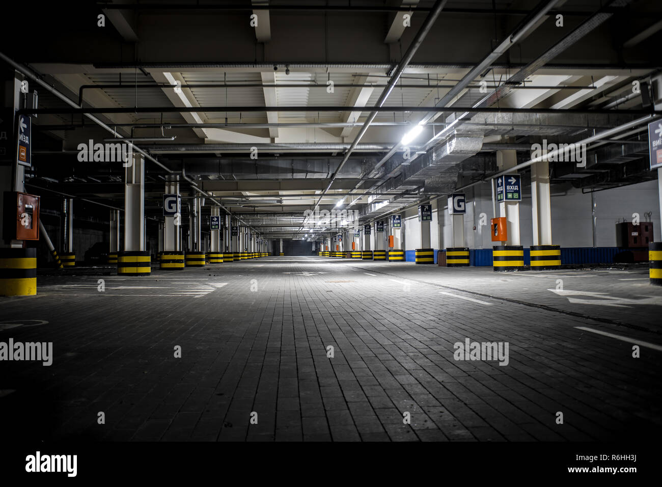 Underground illuminated parking with no people and stripped elements Stock Photo