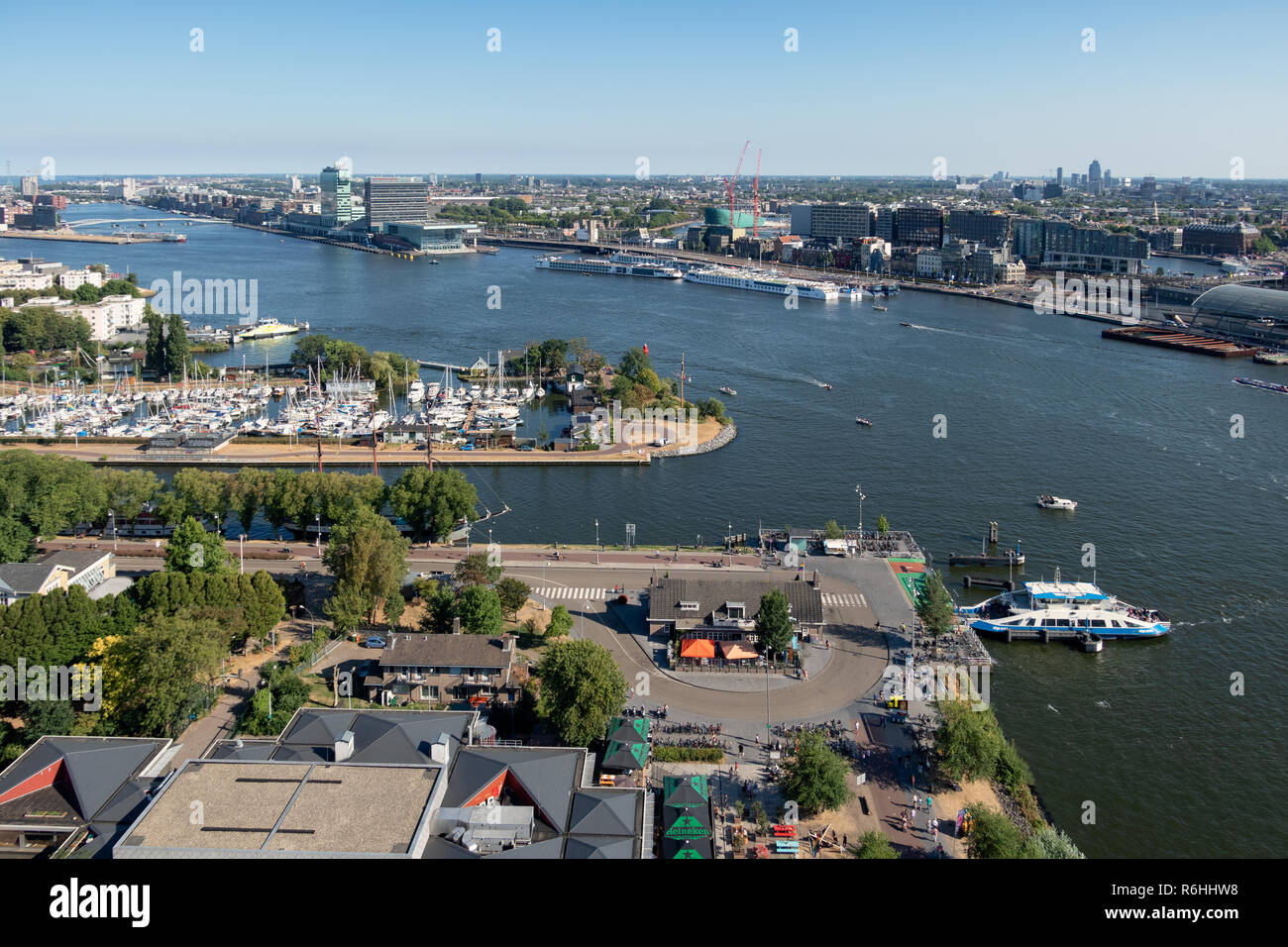 View Dutch harbor Amsterdam with marina, ferry and apartment buildings