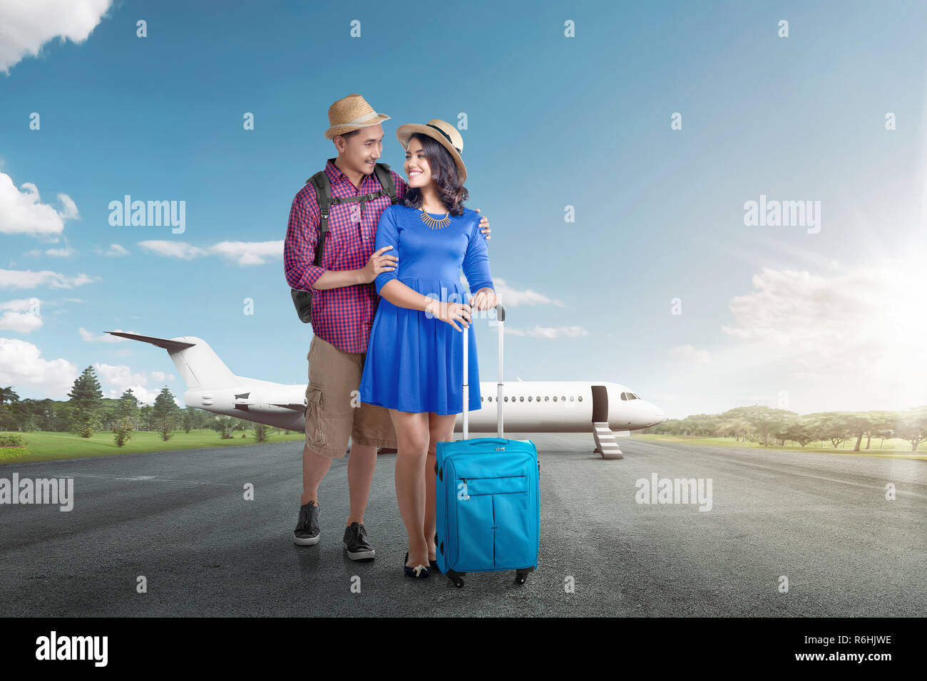 Young asian tourist couple with luggage going traveling with airplane Stock Photo