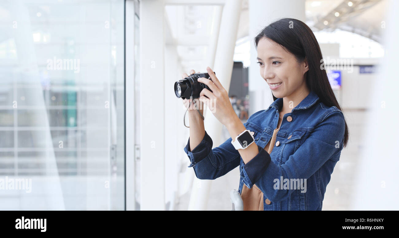 Woman taking photo in Hong Kong airport Stock Photo - Alamy