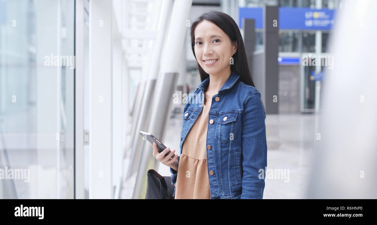 Woman using cellphone in Hong Kong airport Stock Photo - Alamy