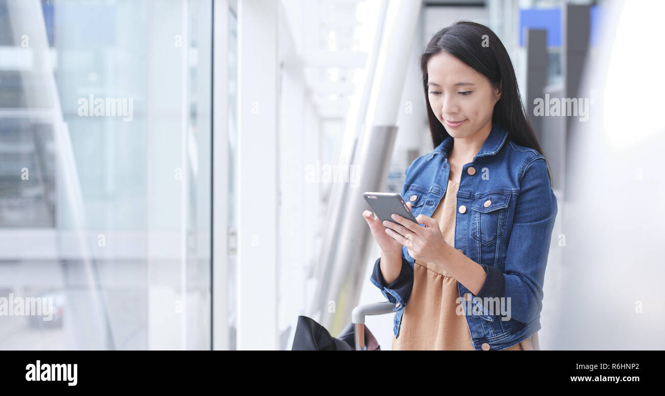Woman use of smart phone in Hong Kong international airport Stock Photo ...