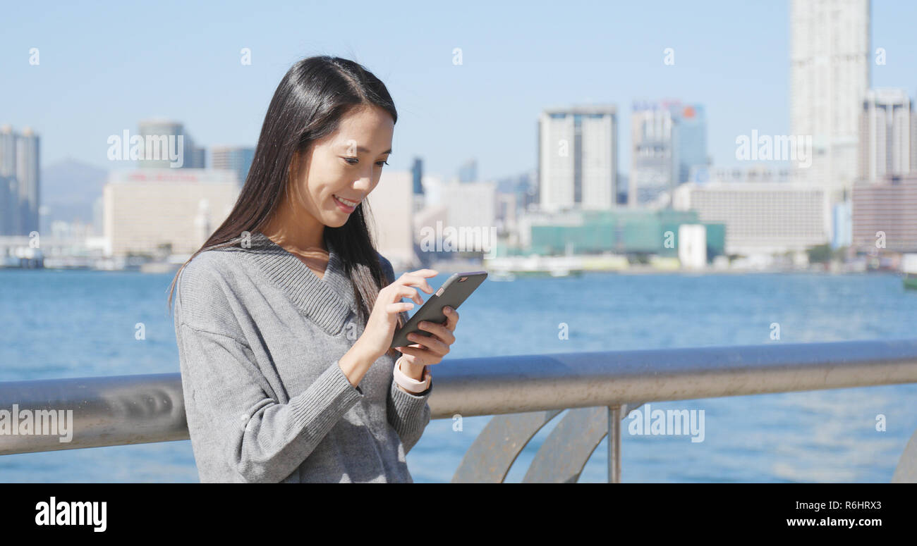 Woman using cellphone in Hong Kong Stock Photo - Alamy
