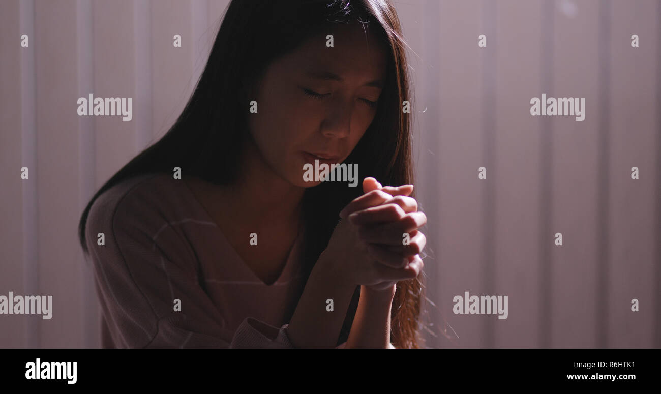 Girl kneeling praying in church hi-res stock photography and images - Alamy