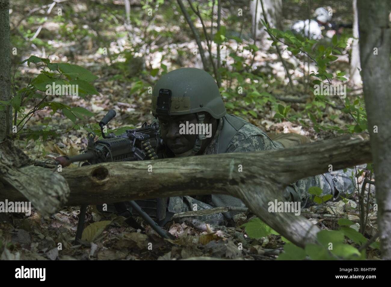 U.S. Army Officer Candidate Isaac Abotsi, assigned to the Hotel Company, 2nd Modular Training Battalion, 124th Regiment (Regional Training Institute), Vermont National Guard, provides security during a bunker clearing lane at New Hampshire National Guard Training Site in Center Strafford, Nh., May 19, 2017. Soldiers from Connecticut, Maine, Massachusetts, New Hampshire, New Jersey, New York, Rhode Island, and Vermont participated in the Officer Candidate School Field Leadership Exercise in preparation for graduation and commission. Stock Photo