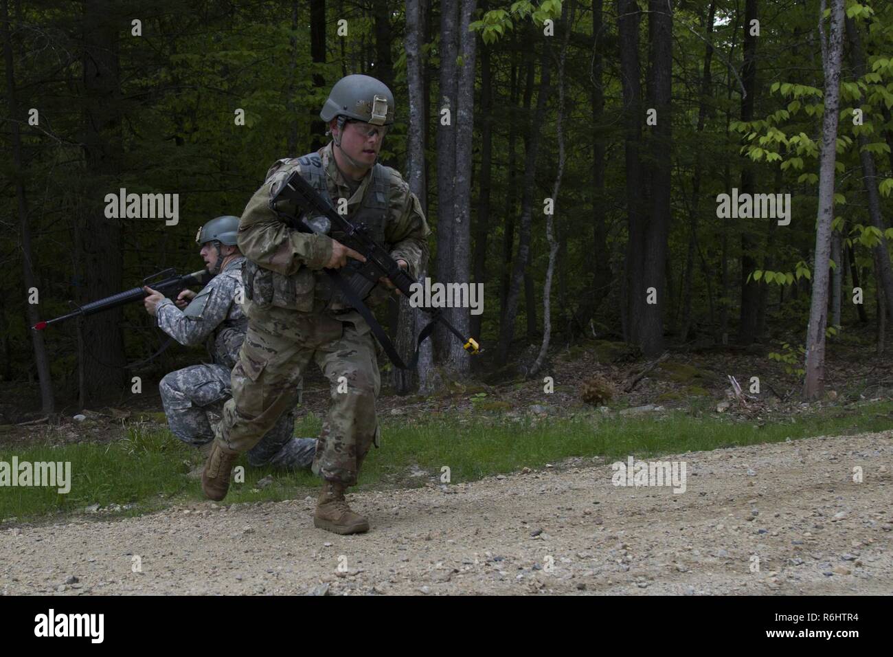 A U.S. Army officer candidate crosses a linear danger area (road) during a reconnaissance operations lane at New Hampshire National Guard Training Site in Center Strafford, Nh., May 19, 2017. Soldiers from Connecticut, Maine, Massachusetts, New Hampshire, New Jersey, New York, Rhode Island, and Vermont participated in the Officer Candidate School Field Leadership Exercise in preparation for graduation and commission. Stock Photo