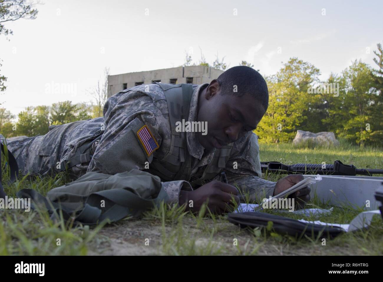 U.S. Army Officer Candidate Isaac Abotsi, with Hotel Company, 2nd Modular Training Battalion, 124th Regiment (Regional Training Institute), Vermont National Guard, plans for an enter and clear a building lane at New Hampshire National Guard Training Site in Center Strafford, Nh., May 19, 2017. Soldiers from Connecticut, Maine, Massachusetts, New Hampshire, New Jersey, New York, Rhode Island, and Vermont participated in the Officer Candidate School Field Leadership Exercise in preparation for graduation and commission. Stock Photo