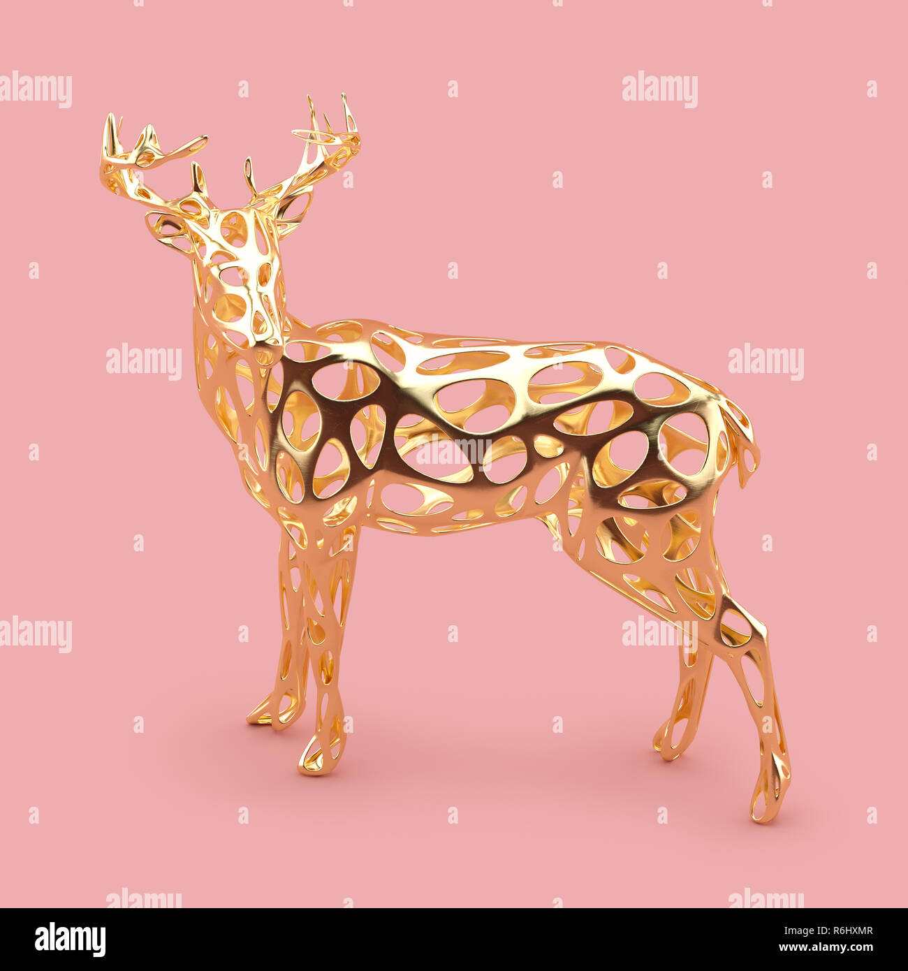 Abstract golden Christmas deer statuette on rose gold background. Stock Photo