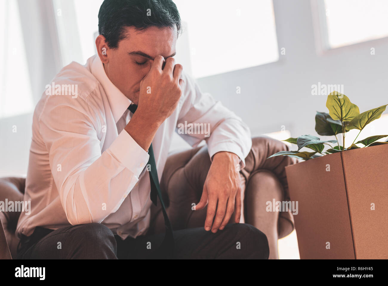 Exhausted dismissed man closing his eyes and thinking Stock Photo