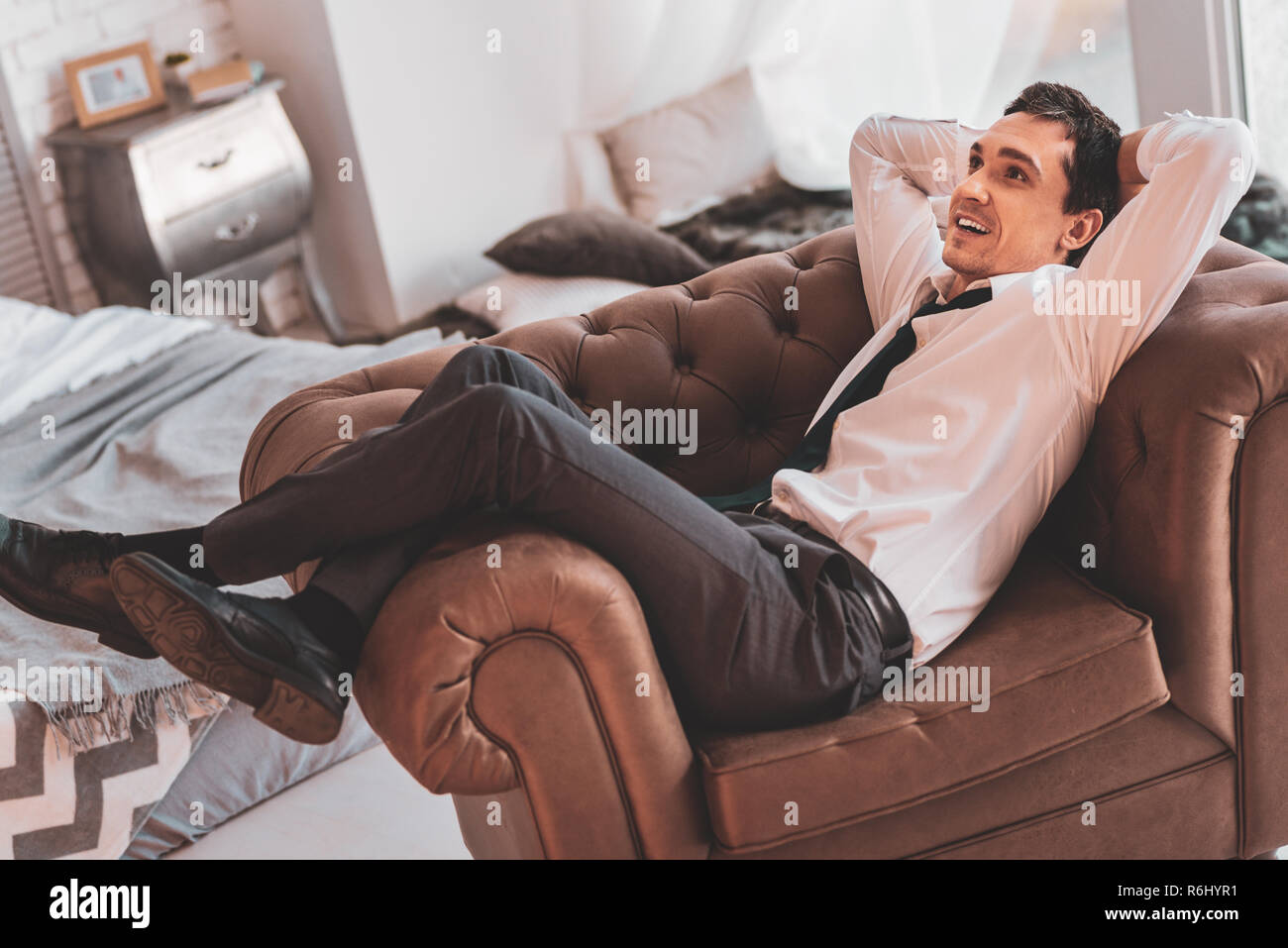 Cheerful man smiling while dreaming about a wonderful career Stock Photo