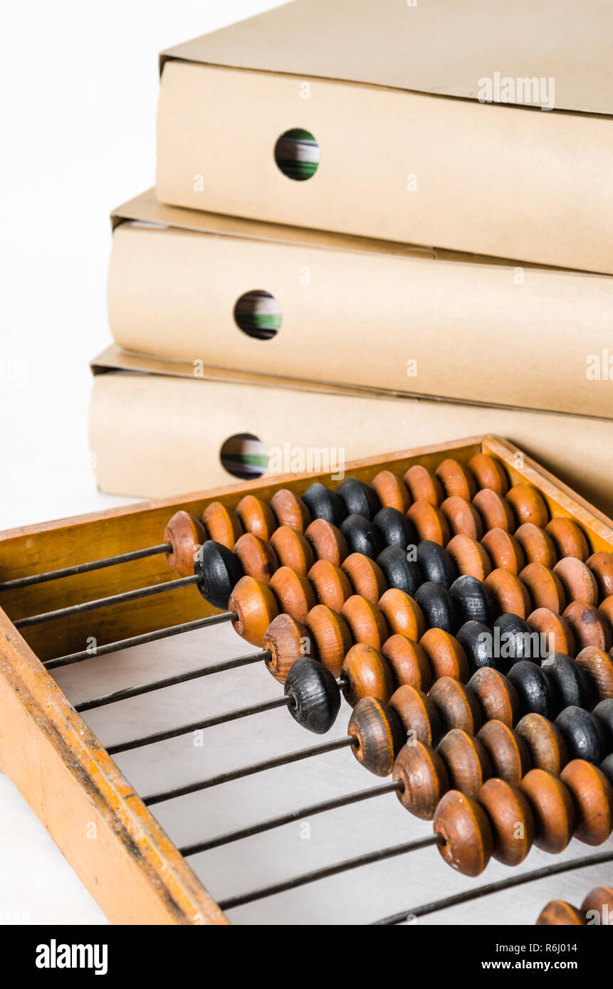 Old abacus and folders with documents, close-up Stock Photo