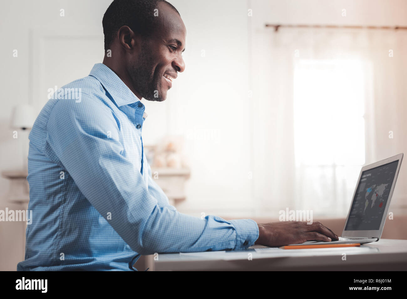Handsome cheerful man working Stock Photo