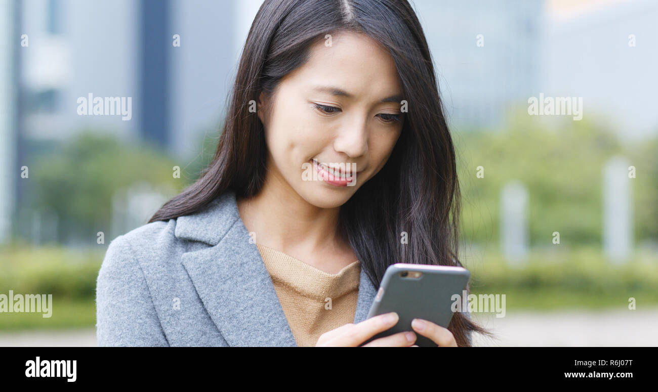 Asian woman use of mobile phone at outdoor Stock Photo - Alamy