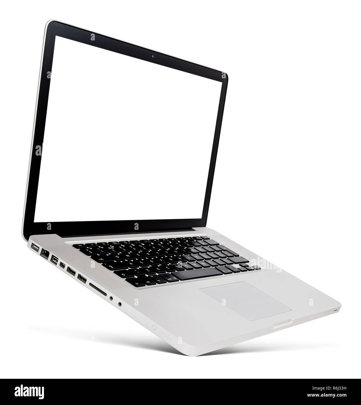 Flying thin aluminium laptop with blank screen, isolated on a white background. Stock Photo