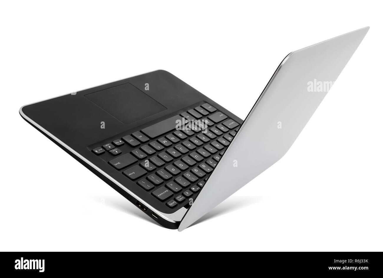 Flying aluminium laptop with a popular design, isolated on a white background. Stock Photo