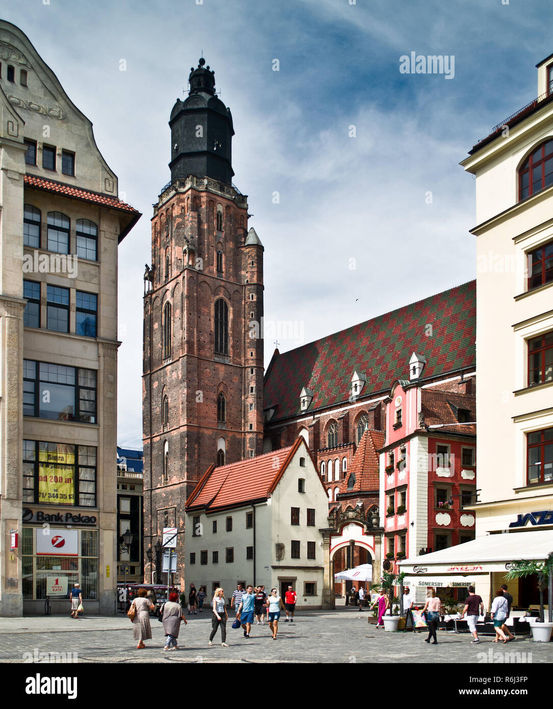 WROCLAW POLAND - August  18 2013: The St Elizabeth Church is hidden behind the houses of old Odrzanska street located next to the Market Square on Aug Stock Photo