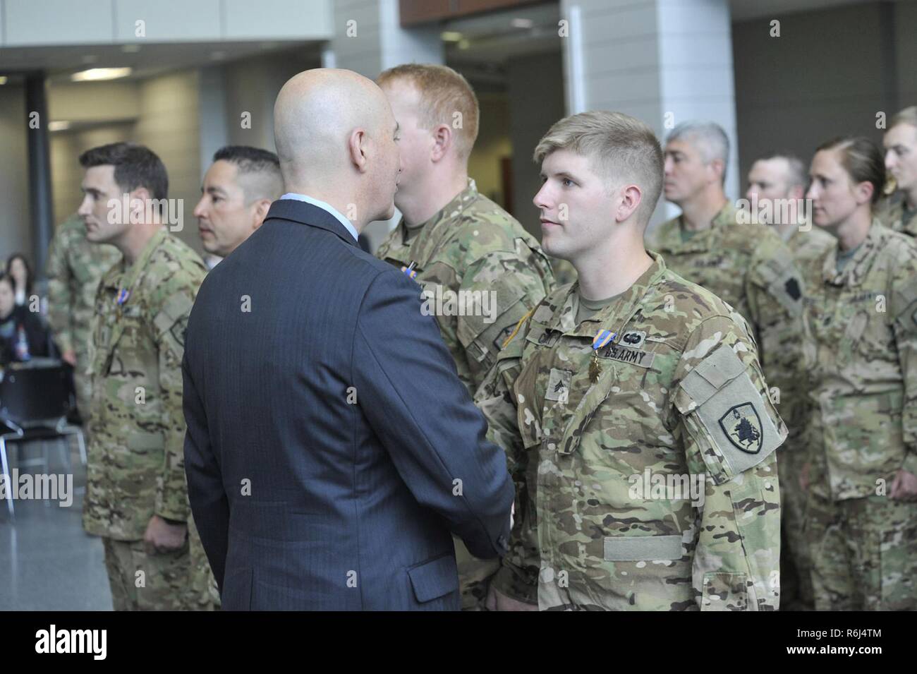 Nebraska Governor Pete Ricketts shakes the hand of Nebraska National Guard Sgt. Jared Cornell