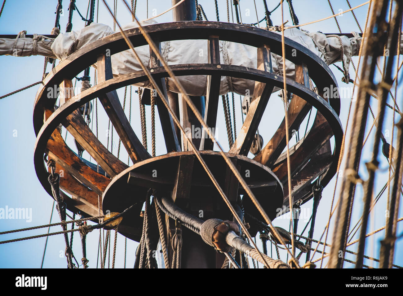 Detail of mast of ship. Detailed rigging with sails. Vintage sailing