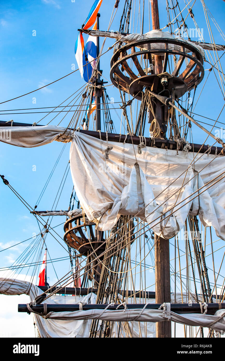 Detail of mast of ship. Detailed rigging with sails. Vintage sailing