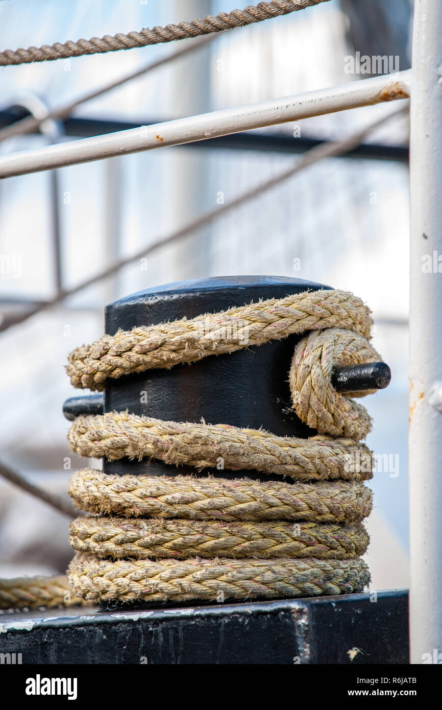 Detail of mast of ship. Detailed rigging with sails. Vintage sailing