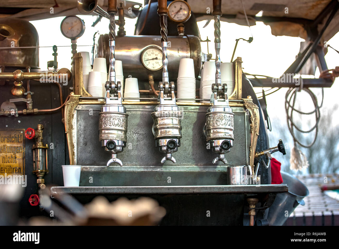 Vintage barista prepare coffee to customer in old style machine with ...