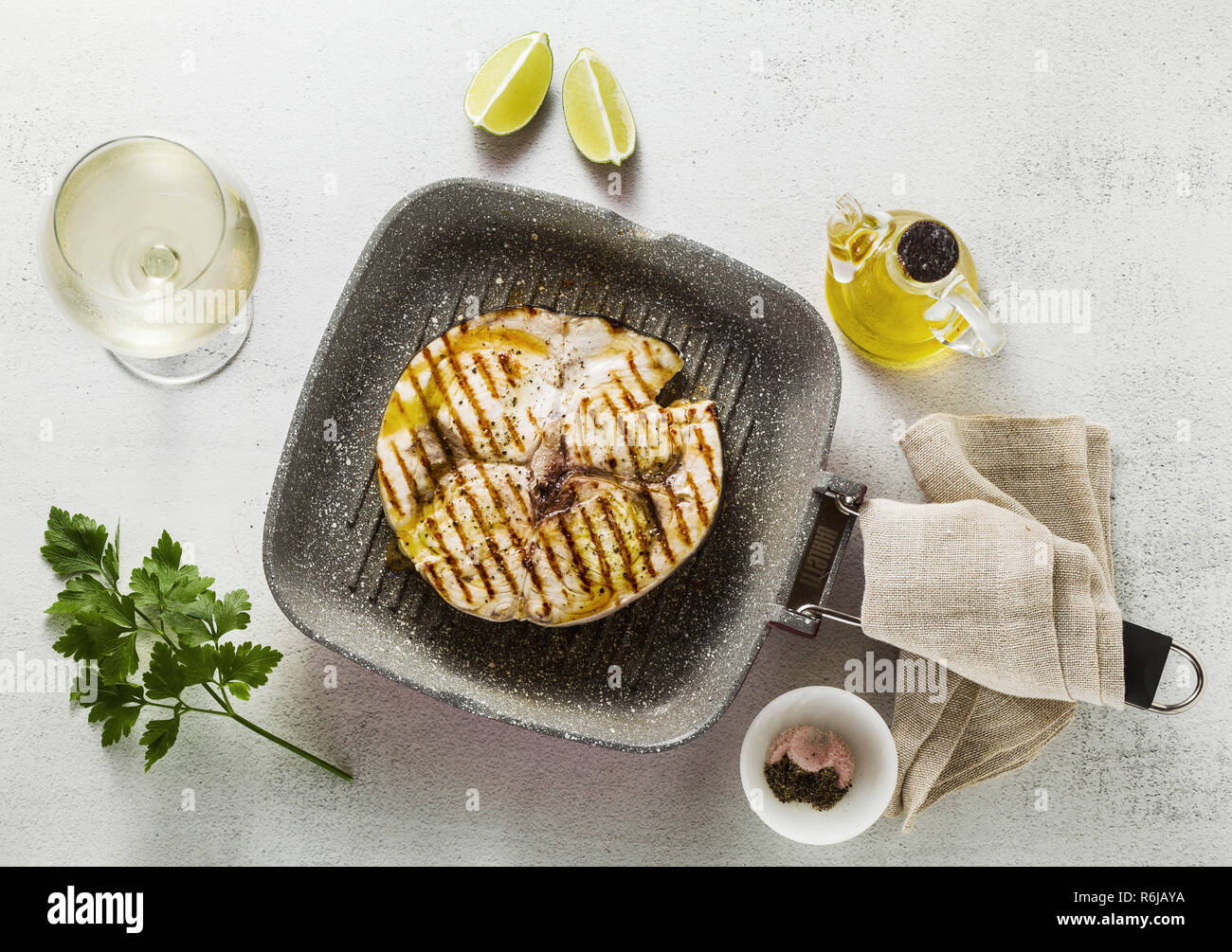 swordfish steak fried on grill pan with olive oil and spices. white