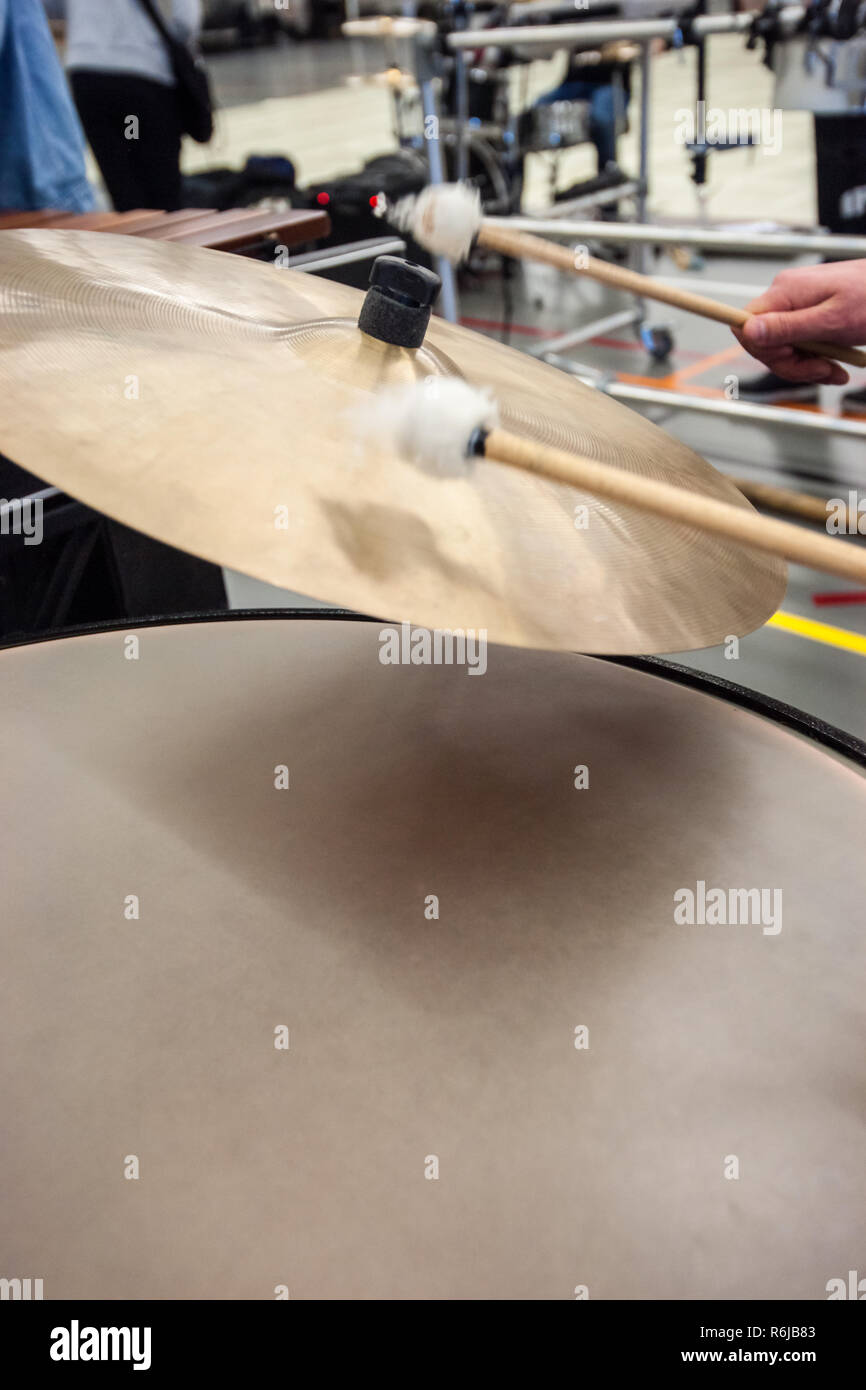 Musician plays the cymbals of a kettledrum with drumstick Stock Photo