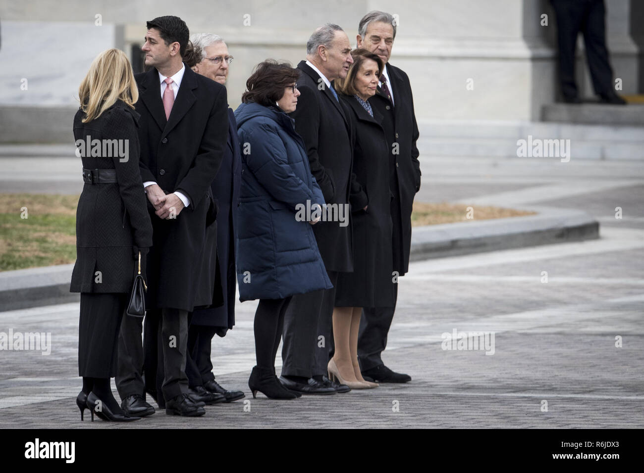 Washington, District of Columbia, USA. 5th Dec, 2018. Congressional leadership including House Speaker Rep. Paul Ryan, Senate Majority Leader Sen. Mitch McConnell, Senate Minority Leader Sen. Chuck Schumer, House Minority Leader Rep. Nancy Pelosi and their respective spouses, gather on the East Front to view the remains of President George H.W. Bush be transported from the U.S. Capitol to the National Cathedral Wednesday December 5, 2018. (Photo by Sarah Silbiger/The New York Times) Credit: Sarah Silbiger/CNP/ZUMA Wire/Alamy Live News Stock Photo
