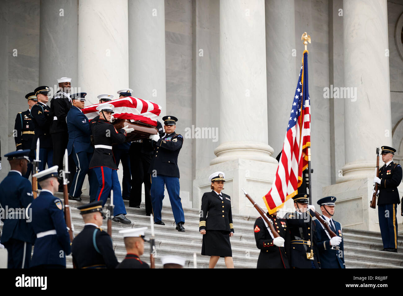 The flag-draped casket of former President George H.W. Bush is carried by a joint services military honor guard from the U.S. Capitol, Wednesday, Dec. 5, 2018, in Washington.  Credit: Shawn Thew / Pool via CNP | usage worldwide Stock Photo
