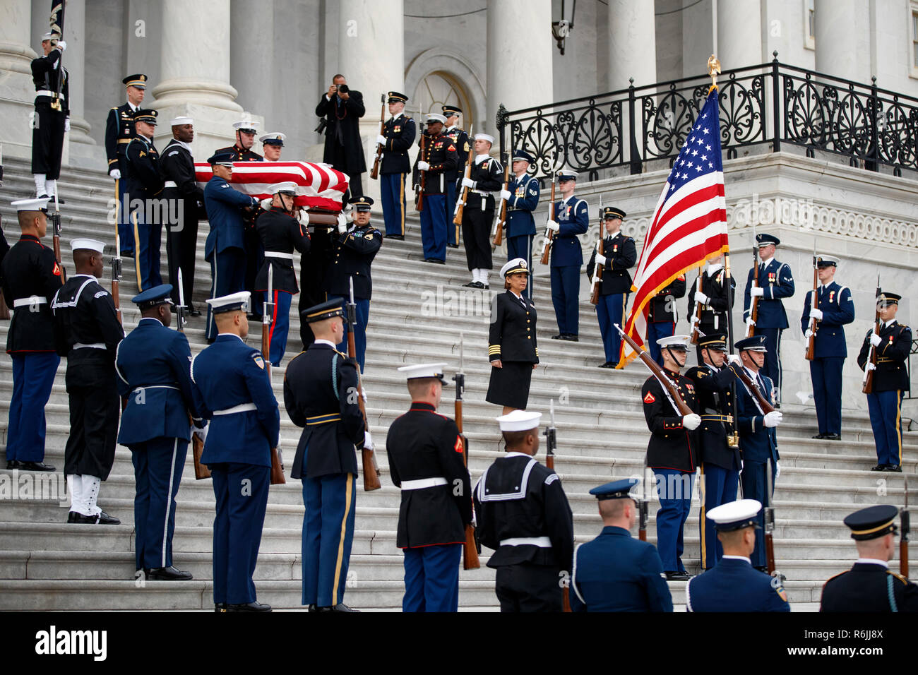 The flag-draped casket of former President George H.W. Bush is carried by a joint services military honor guard from the U.S. Capitol, Wednesday, Dec. 5, 2018, in Washington.  Credit: Shawn Thew / Pool via CNP | usage worldwide Stock Photo
