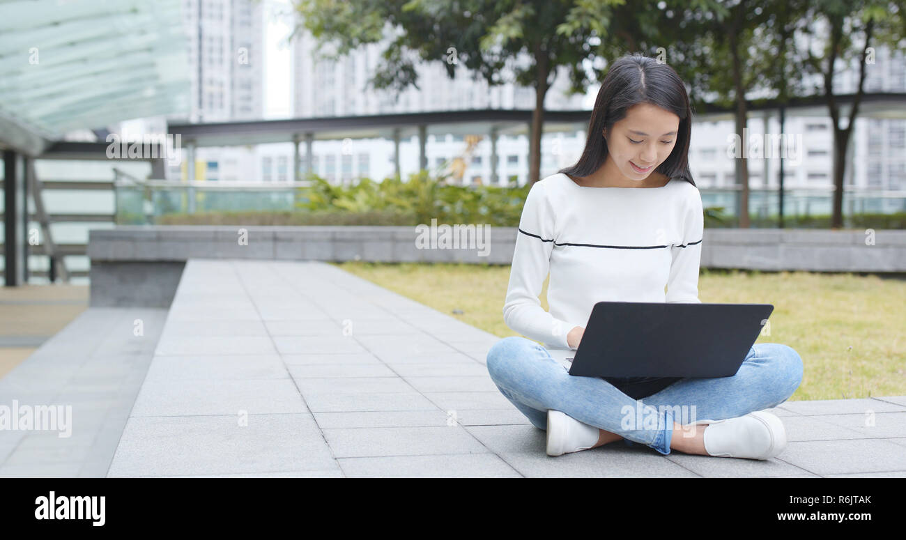 Woman using on laptop computer at outdoor Stock Photo - Alamy