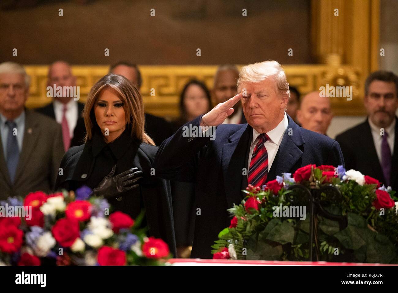 U.S President Donald Trump and First Lady Melania Trump salute as they pay respects to former President George H.W. Bush as they casket lays in state in the U.S. Capitol Rotunda December 3, 2018 in Washington, DC. Bush, the 41st President, died in his Houston home at age 94. Stock Photo
