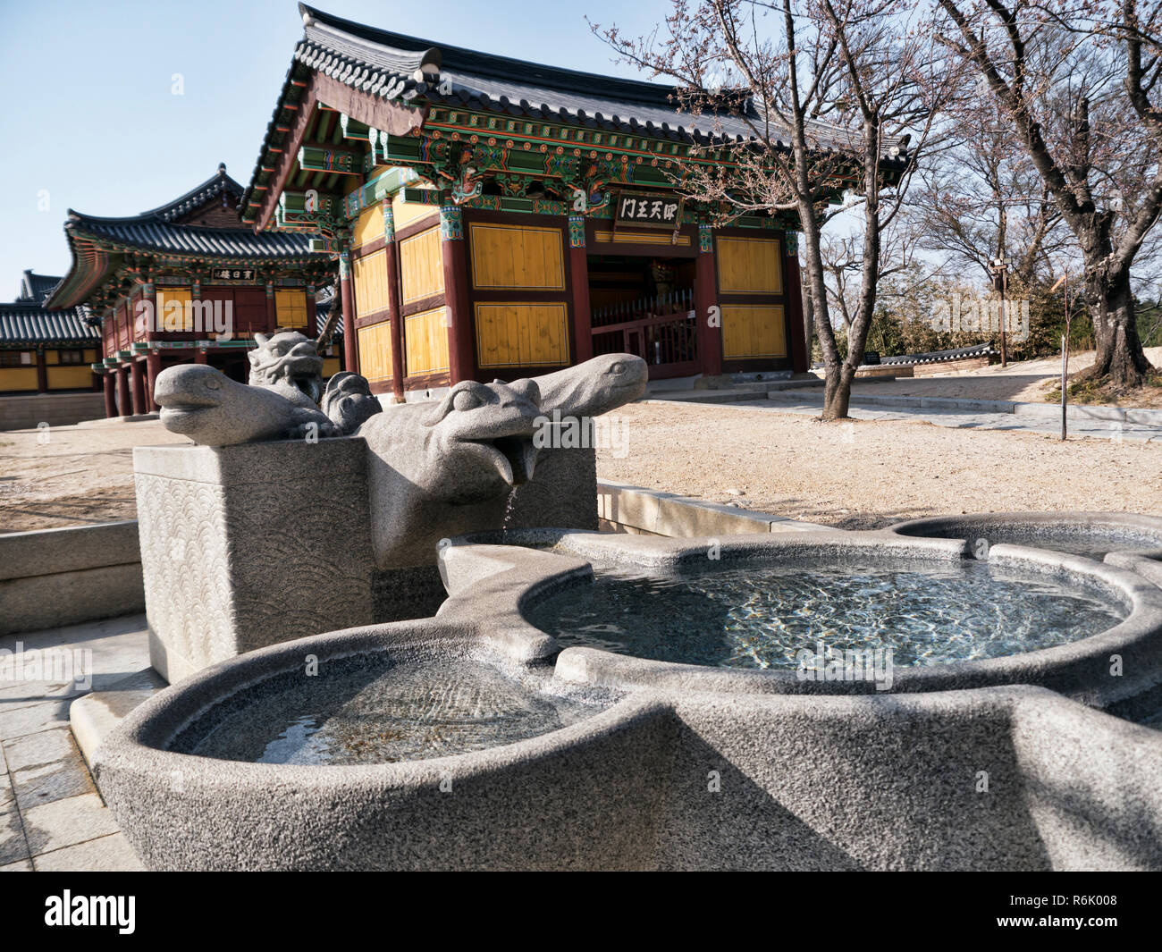 Small stone fountain and traditional asian houses on the background in